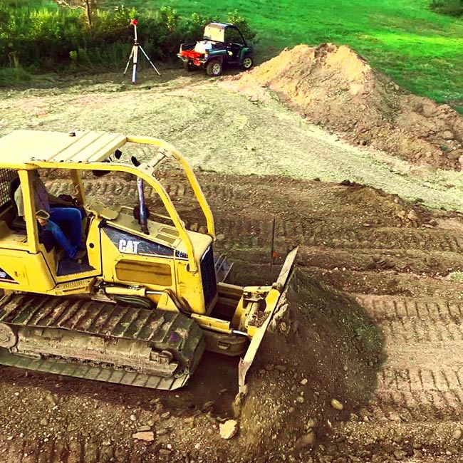 Dirt work contractors moving dirt with a dozer