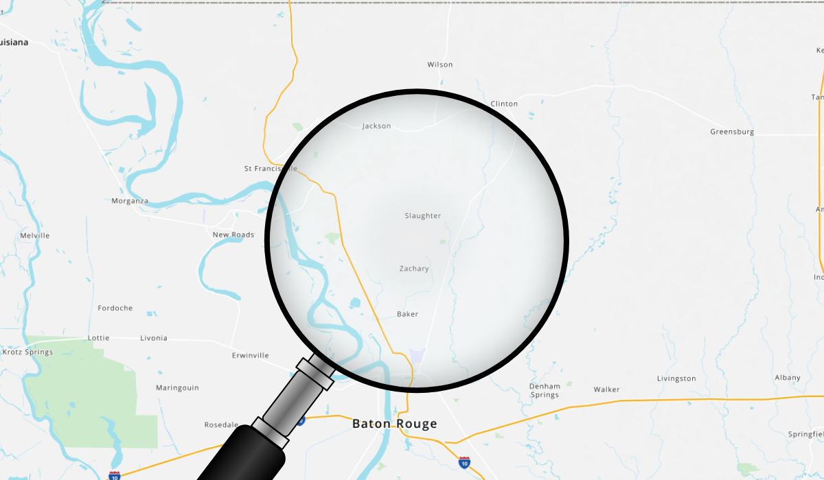 Magnifying glass highlighting Baton Rouge, East Feliciana, and West Feliciana on a blended map of satellite imagery and subdivision layout