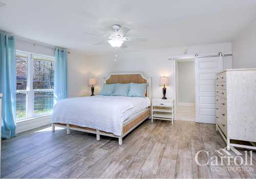 A master bedroom with sliding barn door and wide scenic view
