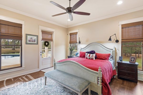 master bedroom with door to outdoor pool and entertainment area.