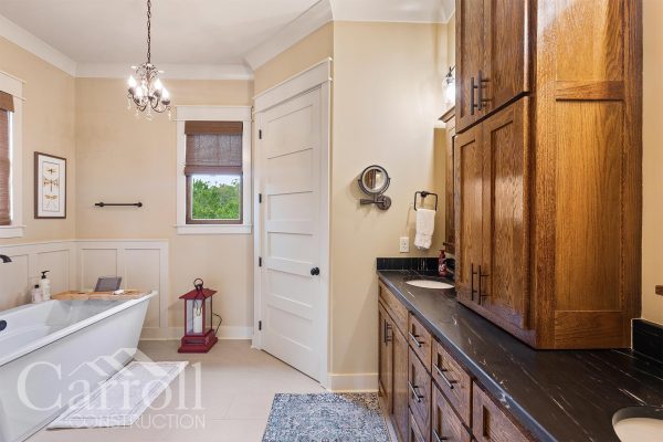 Master bathroom featuring stained oak cabinets and a dark soapstone countertop