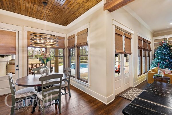 dining room with modern chandelier and double doors to outside entertainment area. Soapstone in the foreground.