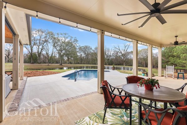 Outside pool area with craftsman style porch columns.