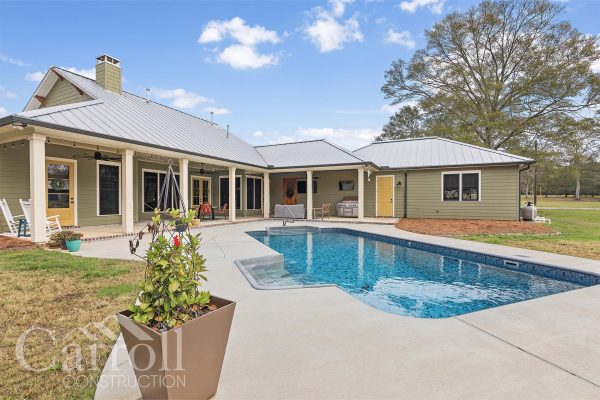 Outside pool area near a craftsman style home