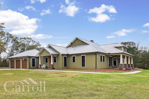 different angle of a front elevation of a craftsman style home with vinyl clad wood windows and a metal roof.