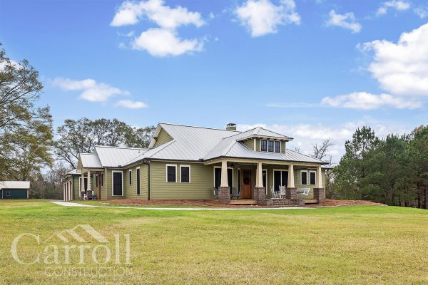 front elevation of a craftsman style home with vinyl clad wood windows and a metal roof.