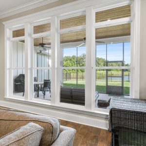 Dittmar Home – Liberty plan, 2,574 SF – living room with exterior window wall, engineered hardwood floors, and abundant natural light.