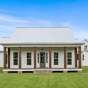 Dittmar Home – Liberty plan, 2,574 SF – front elevation with metal roof, cypress posts, and raised porch.