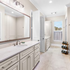 Dittmar Home – Liberty plan, 2,574 SF – master bath vanity with clean lines, framed mirrors, and bright finishes.